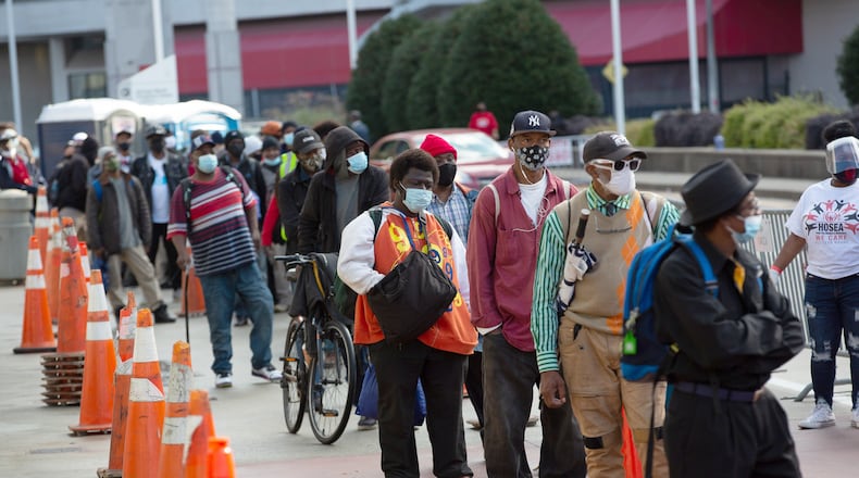 People line up for the annual Hosea Helps Thanksgiving meal distribution outside the Georgia World Congress Center on Thursday, November 26, 2020. The Christmas giveaway event will be drive-thru. (Photo: Steve Schaefer for The Atlanta Journal-Constitution)