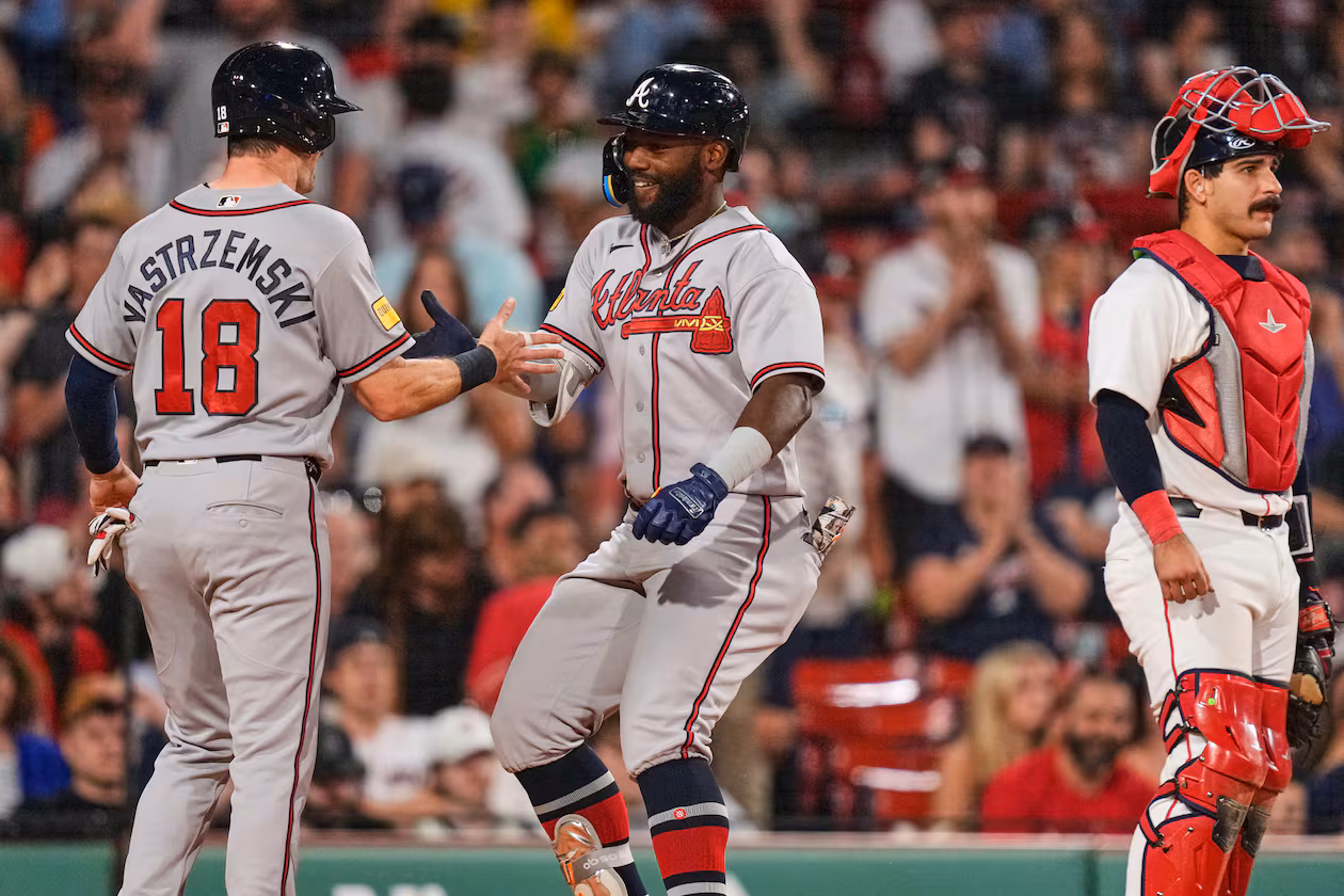 Atlanta Braves' Michael Harris II, center, is congratulated by Mike Yastrzemski (18) after his two-run home run, as Boston Red Sox's Mickey Gasper (30) waits for play to resume, during the eighth inning of a baseball game, Tuesday, May 26, 2026, in Boston. (AP Photo/Charles Krupa)