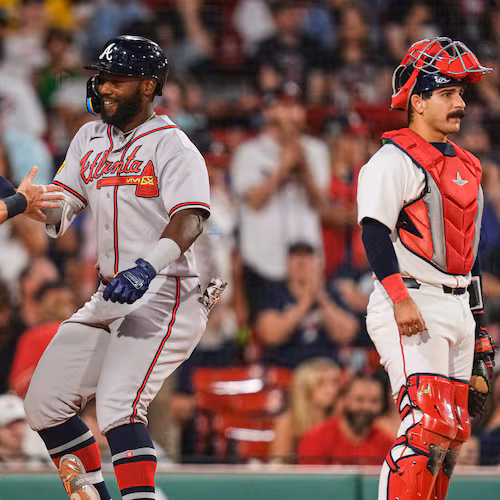 Atlanta Braves' Michael Harris II, center, is congratulated by Mike Yastrzemski (18) after his two-run home run, as Boston Red Sox's Mickey Gasper (30) waits for play to resume, during the eighth inning of a baseball game, Tuesday, May 26, 2026, in Boston. (AP Photo/Charles Krupa)