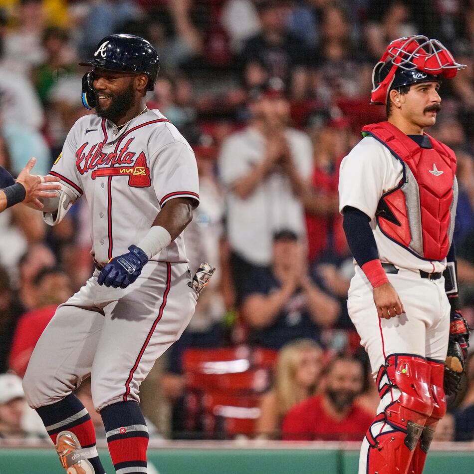 Atlanta Braves' Michael Harris II, center, is congratulated by Mike Yastrzemski (18) after his two-run home run, as Boston Red Sox's Mickey Gasper (30) waits for play to resume, during the eighth inning of a baseball game, Tuesday, May 26, 2026, in Boston. (AP Photo/Charles Krupa)