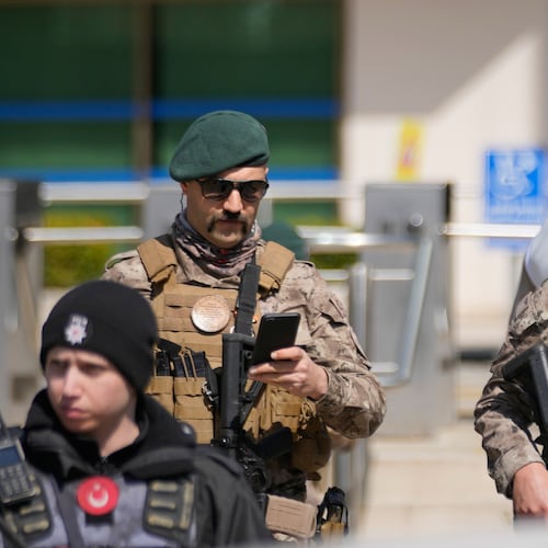 Turkish police and army secure the area after a gunmen attack at a building housing the Israeli Consulate in Istanbul, Turkey, Tuesday, April 7, 2026. (AP Photo/Khalil Hamra)