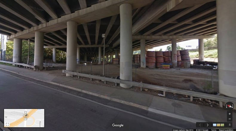This image from Google Maps Street View shows the spools of high-density polyethylene conduit in September 2014, stored under the portion of I-85 that collapsed last week. The conduit is blamed as causing the fire to burn hot enough to collapse the bridge.