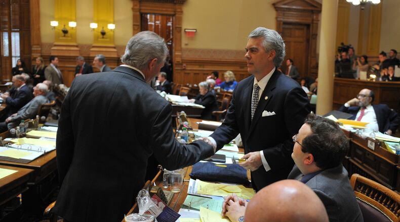 March 3, 2014 Atlanta: Sen. Mike Crane, left, and Sen. Judson Hill, celebrate the passage of Hill's SB98 Monday. The bill would remove funding for certain abortions under some insurance plans. Today is the last day for bills to pass either the House or Senate. Bills that do not clear at least one chamber today will not have a chance of passing this session. BRANT SANDERLIN /BSANDERLIN@AJC.COM