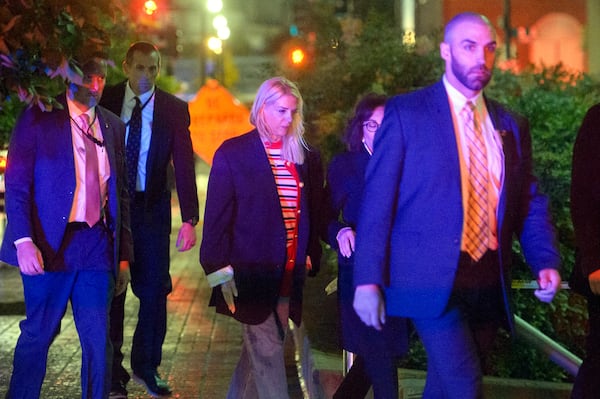 Attorney General Pam Bondi, center, walks to her car as law enforcement work the scene after two staff members of the Israeli Embassy in Washington were shot and killed outside the Capital Jewish Museum, Thursday, May 22, 2025, in Washington. (AP Photo/Rod Lamkey, Jr.)