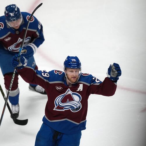Colorado Avalanche center Nathan MacKinnon, front, and left wing Artturi Lehkonen react after center Martin Necas scored a goal against the Minnesota Wild in the first period of Game 2 of an NHL hockey Stanley Cup second-round playoff series Tuesday, May 5, 2026, in Denver. (AP Photo/David Zalubowski)