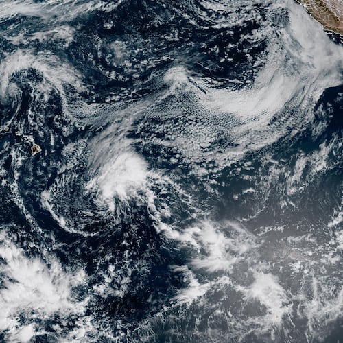 This satellite image released by NOAA shows Hurricane Lala, upper left, over the Pacific Ocean, northwest of Hawaii, Friday, Aug. 21, 2026. (NOAA via AP)