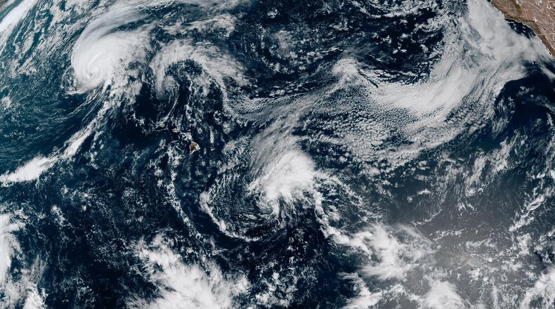 This satellite image released by NOAA shows Hurricane Lala, upper left, over the Pacific Ocean, northwest of Hawaii, Friday, Aug. 21, 2026. (NOAA via AP)
