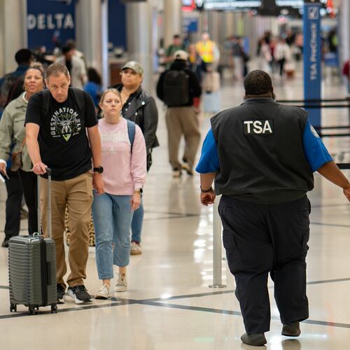 A TSA officer walks through Terminal South at Hartsfield-Jackson Atlanta International Airport on March 30, 2026. More workers are returning to the airport now that they're being paid again. (Ben Hendren for the AJC)