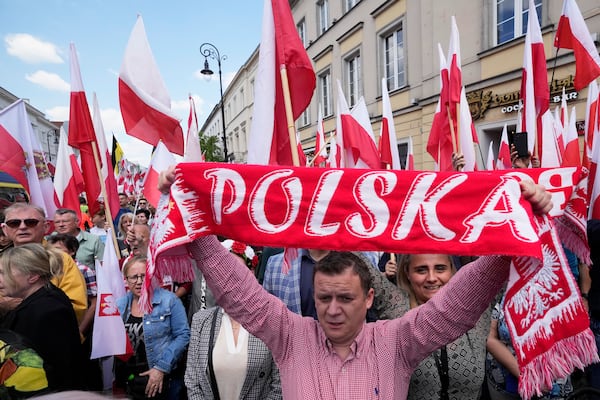Supporters of conservative presidential candidate Karol Nawrocki take part in a march one week ahead of a decisive election in Warsaw Poland, Sunday, May 25, 2025. (AP Photo/Czarek Sokolowski)