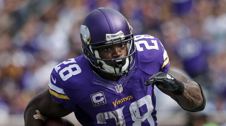 Minnesota Vikings running back Adrian Peterson (28) rushes against the Detroit Lions at TCF Bank Stadium.