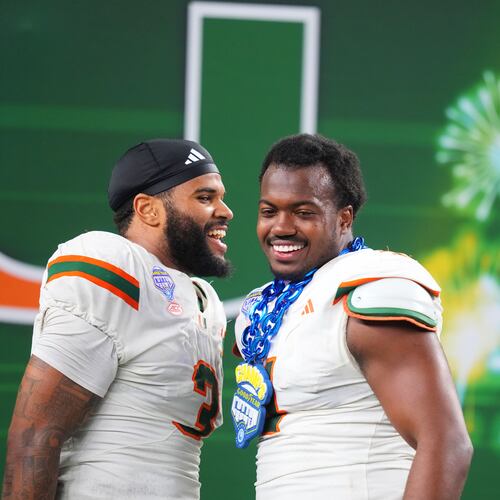 Miami defensive lineman Akheem Mesidor, left, and defensive lineman Rueben Bain Jr. react following the Cotton Bowl College Football Playoff quarterfinal game against Ohio State Wednesday, Dec. 31, 2025, in Arlington, Texas. (AP Photo/Julio Cortez)
