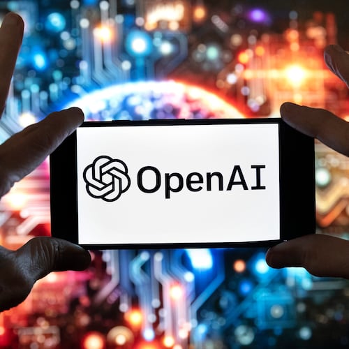 FILE - The OpenAI logo is displayed on a cell phone in front of an image generated by ChatGPT's Dall-E text-to-image model, Dec. 8, 2023, in Boston. (AP Photo/Michael Dwyer, File)