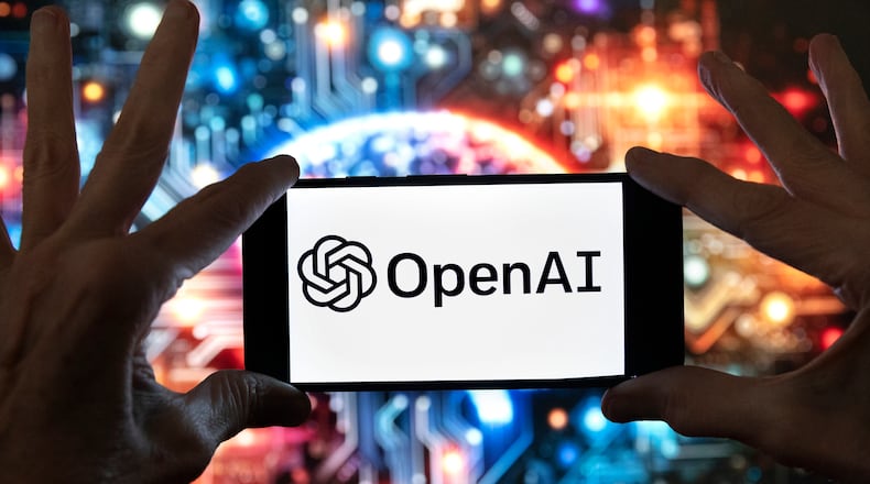 FILE - The OpenAI logo is displayed on a cell phone in front of an image generated by ChatGPT's Dall-E text-to-image model, Dec. 8, 2023, in Boston. (AP Photo/Michael Dwyer, File)