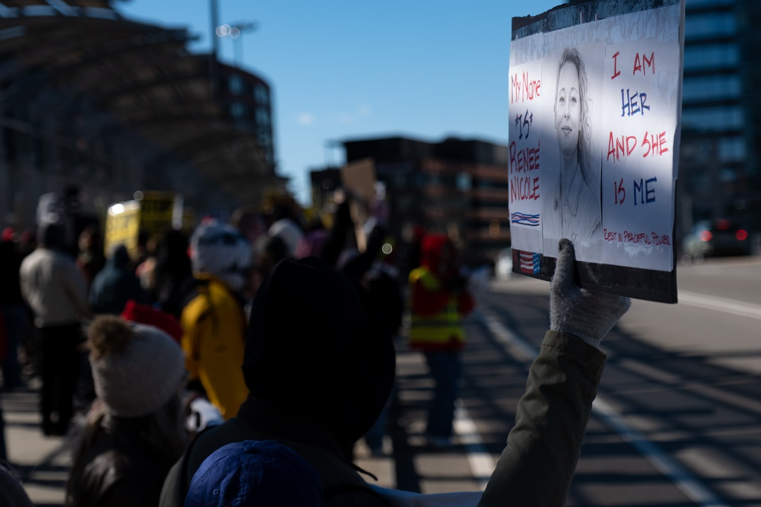 A woman who shares the name Reneé Nicolejoins others on the 17th Street Bridge in Atlanta on Sunday, Jan. 11, 2026 to protest the ICE shooting of Renee Good and the US military action in Venezuela. Ben Gray for the Atlanta Journal-Constitution