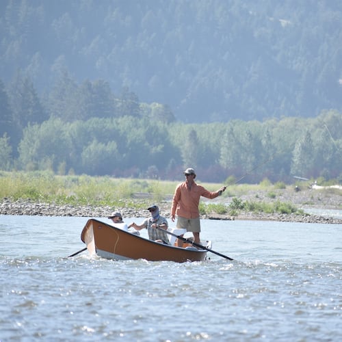 A drift boat with people fly fishing floats down the Yellowstone River, Friday, July 31, 2026, near Livingston, Montana. (AP Photo/Matthew Brown)