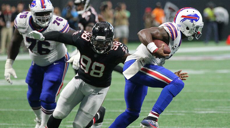 October 1, 2017 Atlanta: Buffalo Bills quarterback Tyrod Taylor slips away from the pass rush of Falcons defensive end Takkarist McKinley for a first down run during the second half in a NFL football game on Sunday, October 1, 2017, in Atlanta. The Bills defeated the Falcons 23-17. Curtis Compton/ccompton@ajc.com
