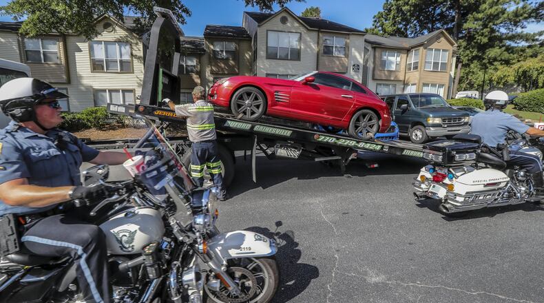 Gwinnett police officers work a crime scene near Duluth on Aug. 7, 2018. The Gwinnett County Police Department is in the process of rolling out body-worn cameras for all of its officers. The agency’s motorcycle unit was among the first to receive cameras. JOHN SPINK/JSPINK@AJC.COM