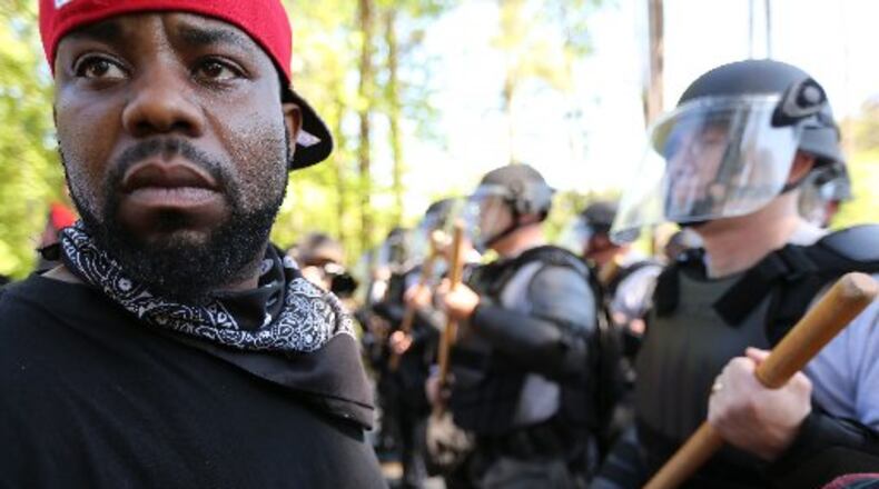 April 23, 2016 Stone Mountain: LaJuan WIlliams turns away from police while taking part in a counter protest at Stone Mountain Park on Saturday afternoon April 23, 2016. A white power protest and two counter protests were took place at the park. Ben Gray / bgray@ajc.com