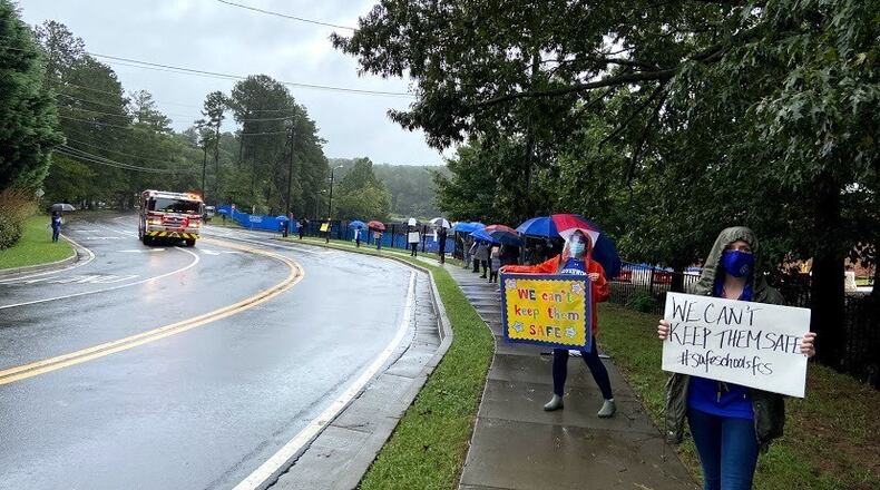 Fulton County Schools teachers and children protest the district's plan of returning to face-to-face instruction with a walkout during lunch on Thursday, Sept. 17, 2020.