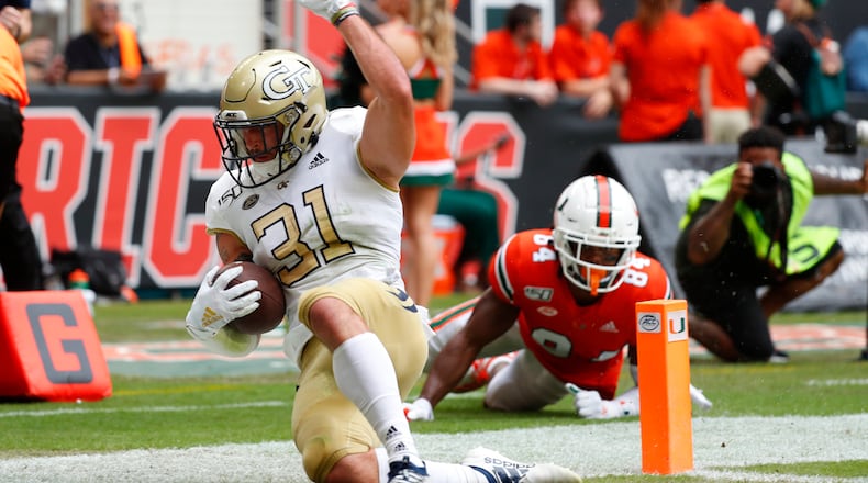 Georgia Tech running back Nathan Cottrell (31) scores against Miami defensive lineman Josh Neely (84) during the first half of an NCAA college football game, Saturday, Oct. 19, 2019, in Miami Gardens, Fla. (AP Photo/Wilfredo Lee)
