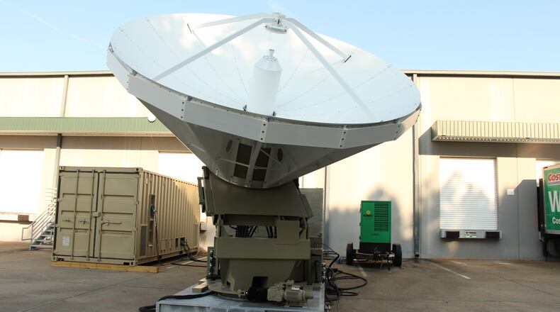 Atlanta military contractor Envistacom, which is opening a new engineering office in Duluth, supplies equipment like this 4.8 meter satellite communications dish and equipment shelter (left) that can be deployed to remote military sites. Photo courtesy of Envistacom.