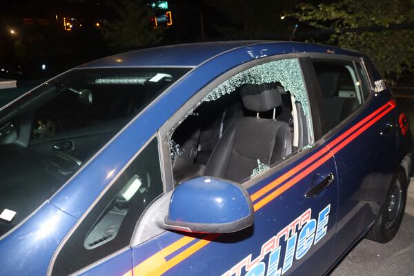 An hour before motorcycles were set on fire at an Atlanta Police Department precinct, officials allege the same group was involved in the smashing of windows at a precinct on Memorial Drive.