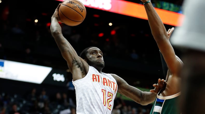 Atlanta Hawks forward Taurean Prince (12) scores against Milwaukee Bucks center Greg Monroe (15) in the first half of an NBA basketball game Wednesday, Nov. 16, 2016, in Atlanta. (AP Photo/John Bazemore)