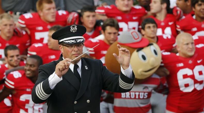 In this Sept. 7, 2013 photo, Ohio State University marching band director Jon Waters leads the band in "Carmen Ohio" following a NCAA football game against San Diego State at Ohio Stadium in Columbus, Ohio. OSU on Thursday, July 24, 2014 fired Waters amid allegations he knew about and ignored "serious cultural issues" including sexual harassment. (AP Photo/The Columbus Dispatch, Adam Cairns) Ohio State University marching band director Jon Waters leads the band in a 2013 photo. (AP Photo/The Columbus Dispatch, Adam Cairns)