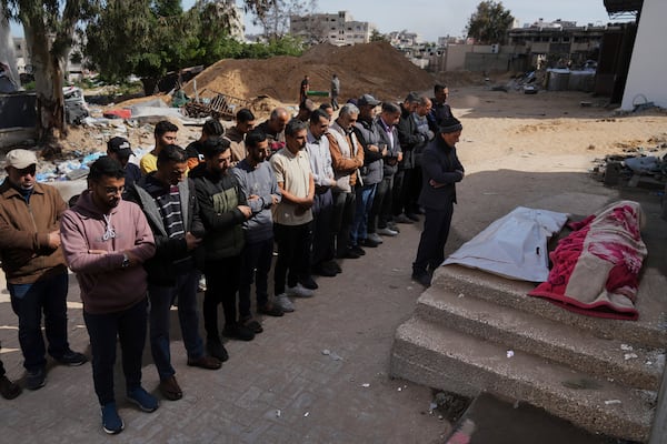 Mourners pray over the bodies of Palestinians killed in an Israeli airstrike during their funeral at Shifa Hospital in Gaza City, Wednesday, April 16, 2025. (AP Photo/Jehad Alshrafi)