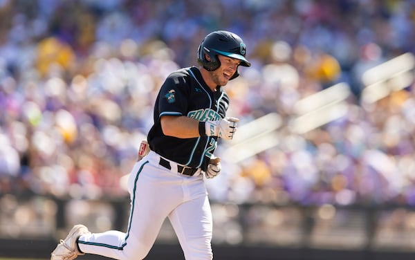 Coastal Carolina's Wells Sykes celebrates as he rounds the bases after hitting a two-run home run against LSU in the seventh inning of Game 2 of the NCAA College World Series baseball finals in Omaha, Neb., Sunday, June 22, 2025. (AP Photo/Rebecca S. Gratz)