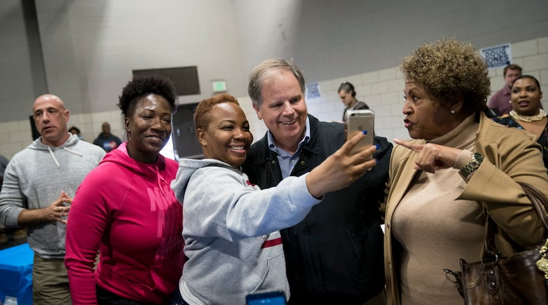 BIRMINGHAM, AL - NOVEMBER 18: Democratic candidate for U.S. Senate Doug Jones takes photos with supporters before speaking at a fish fry campaign event at Ensley Park, November 18, 2017 in Birmingham, Alabama. Jones has moved ahead in the polls of his Republican opponent Roy Moore, whose campaign has been rocked by multiple allegations of sexual misconduct. (Photo by Drew Angerer/Getty Images)