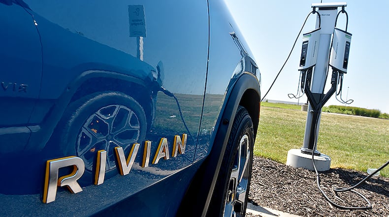 The Rivian R1T electric vehicle is connected to a charging station outside the Rivian Plant in Normal, Ill., on July 20, 2022. (Photo for the Atlanta Journal Constitution by Ron Johnson)