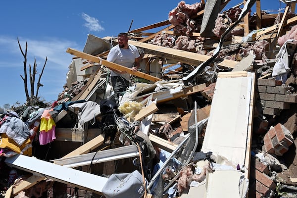 Anthony Broughton stands amid his destroyed home following severe weather in the Sunshine Hill neighborhood of London, Ky., Saturday, May 17, 2025. (AP Photo/Timothy D. Easley)