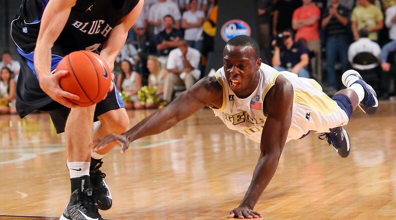 Georgia Tech guard Mfon Udofia dives for a lose ball that is snatched away by Presbyterian guard Austin Anderson during 2nd half action at McCamish Pavilion in Atlanta on Wednesday, Nov. 14, 2012. CURTIS COMPTON / CCOMPTON@AJC.COM