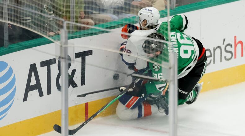 Dallas Stars right wing Mikko Rantanen (96) collides with New York Islanders defenseman Alexander Romanov (28) during the third period of an NHL hockey game, Tuesday, Nov. 18, 2025, in Dallas. (AP Photo/Gareth Patterson)