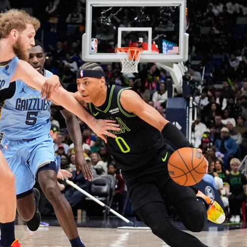 New Orleans Pelicans guard Jeremiah Fears (0) drives to the basket against Memphis Grizzlies center Jock Landale (31) and guard Vince Williams Jr. (5) in the first half of an NBA basketball game, Friday, Jan. 30, 2026, in New Orleans. (AP Photo/Avery Sikes)