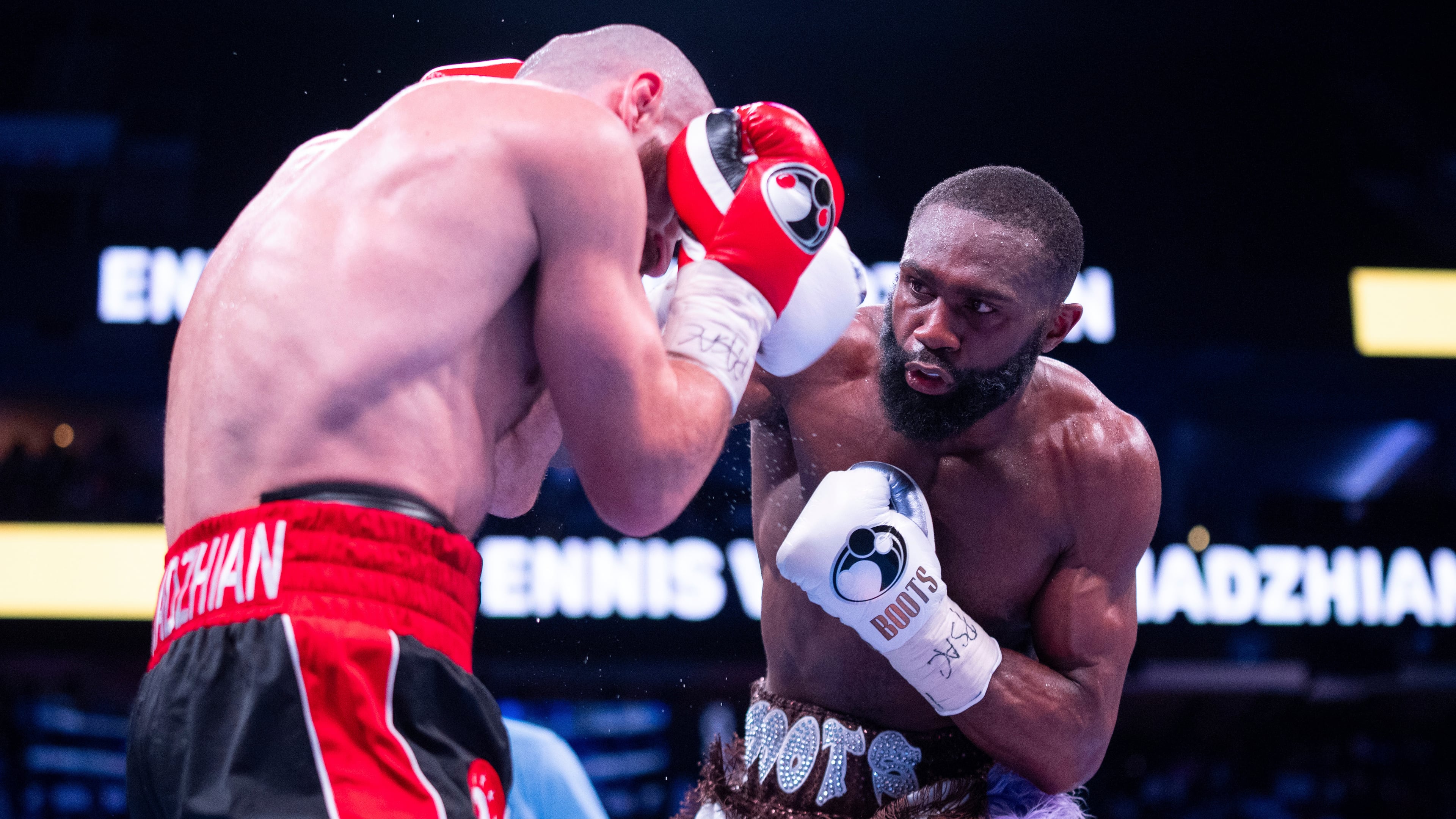 FILE - Jaron Ennis, right, throws a punch at Karen Chukhadzhian, left, during the ninth round IBF World Welterweight title bout, Nov. 9, 2024, in Philadelphia. (AP Photo/Chris Szagola, File)