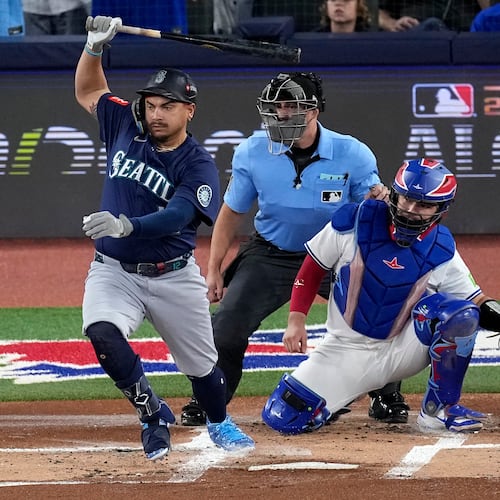 Seattle Mariners' Josh Naylor follows through on an RBI base hit off Toronto Blue Jays pitcher Shane Bieber (57) during the first inning in Game 7 of baseball's American League Championship Series, Monday, Oct. 20, 2025, in Toronto. (AP Photo/David J. Phillip)