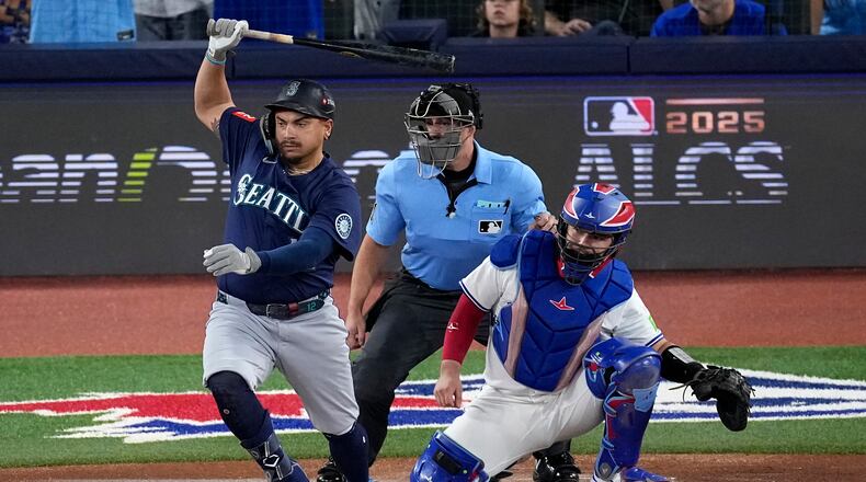 Seattle Mariners' Josh Naylor follows through on an RBI base hit off Toronto Blue Jays pitcher Shane Bieber (57) during the first inning in Game 7 of baseball's American League Championship Series, Monday, Oct. 20, 2025, in Toronto. (AP Photo/David J. Phillip)