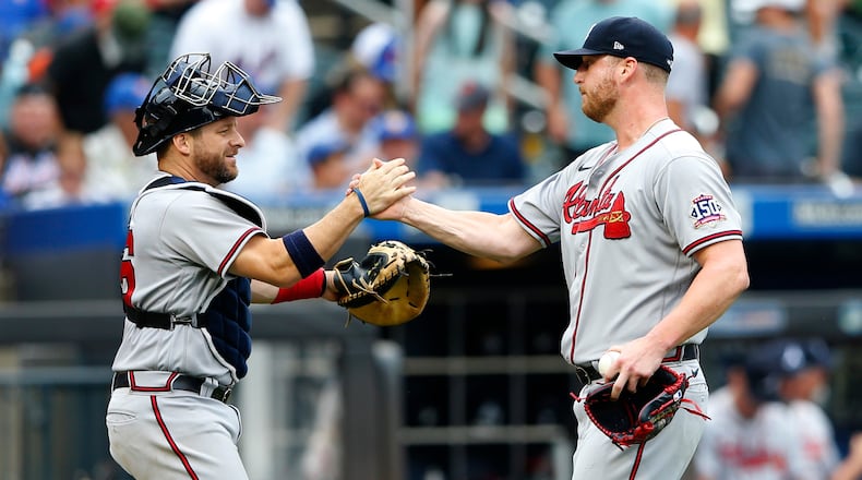 Atlanta Braves catcher Stephen Vogt shakes hands with relief pitcher Will Smith after defeating the New York Mets 6-3, Thursday, July 29, 2021, in New York. (AP Photo/Noah K. Murray)