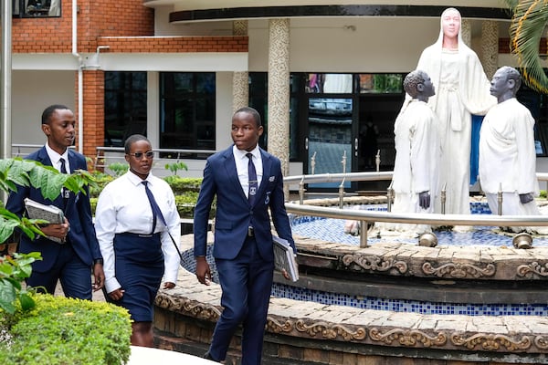 Students walk past the administration block at Uganda Martyrs' Secondary School Namugongo, in Kampala, Uganda Monday, May 26, 2025. (AP Photo/Hajarah Nalwadda)