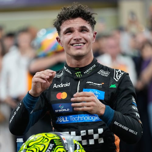 McLaren driver Lando Norris of Britain reacts after becoming a world champion after the Abu Dhabi Formula One Grand Prix in Abu Dhabi, United Arab Emirates, Sunday, Dec. 7, 2025. (AP Photo/Darko Bandic)