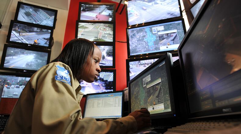 Crystal Jones, dispatcher with Midtown Blue, a 24/7 security force of off-duty police officers, uses a joystick to change the view of one of the 44 cameras she monitors. File photo. Brant Sanderlin bsanderlin@ajc.com