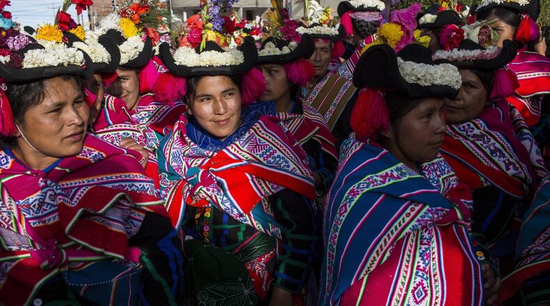 In this Jan. 29, 2017 photo, dancers wait their turn to perform during Virgin of Candelaria celebrations in Puno, Peru. In addition to devotion, villagers have other reasons for dancing on the feast. Some are grateful to have been cured of disease, while others are asking for protection for their crops, or increased political power. (AP Photo/Rodrigo Abd)