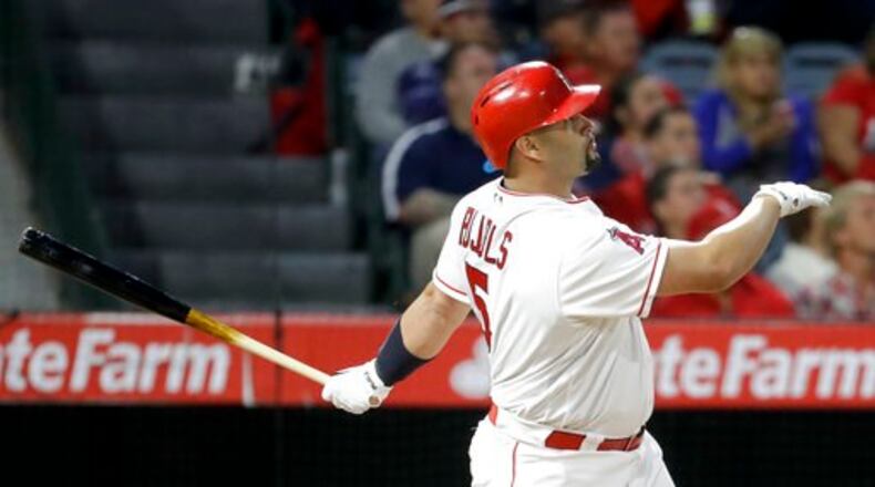Albert Pujols watches his three-run homer off Braves pitcher Bartolo Colon in a nine-run third inning late Tuesday. It was the 599th home run of Pujols’ career. (AP Photo/Chris Carlson)