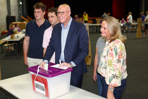 Australian Liberal Party leader Peter Dutton stands with his sons, Tom and Harry and his wife Kirilly as he votes in his electorate in Brisbane, Australia, Saturday, May 3, 2025. (AP Photo/Pat Hoelscher)