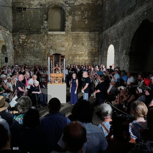 People listen to the sound of the John Cage Organ Project Halberstadt during a chord change of the organ inside the medieval Burchardi Church in Halberstadt, Germany, Wednesday, Aug. 5, 2026. (AP Photo/Markus Schreiber)