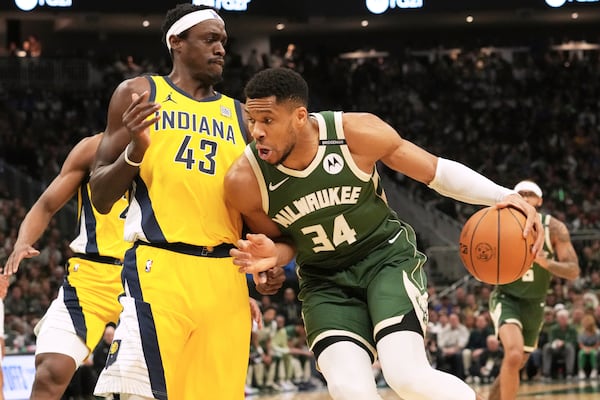 Milwaukee Bucks forward Giannis Antetokounmpo, right, drives against Indiana Pacers forward Pascal Siakam (43) during the first half in Game 3 of an NBA basketball first-round playoff series Friday, April 25, 2025, in Milwaukee. (AP Photo/Nam Y. Huh)