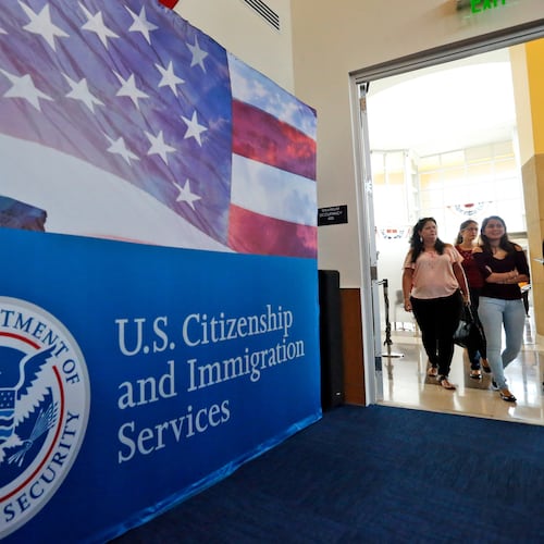 FILE - In this Aug. 17, 2018, file photo, people arrive before the start of a naturalization ceremony at the U.S. Citizenship and Immigration Services Miami Field Office in Miami. (AP Photo/Wilfredo Lee, File)