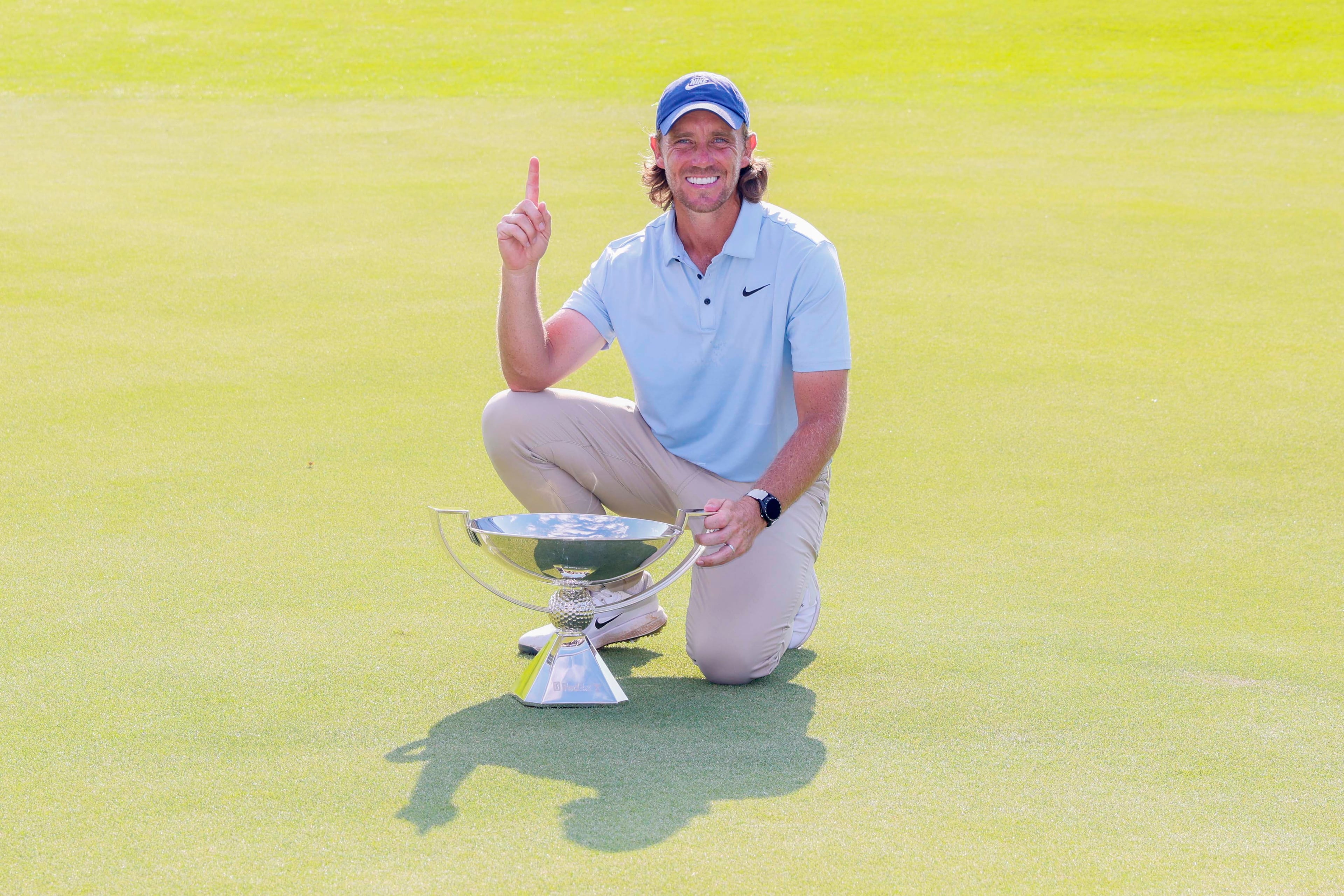 Tommy Fleetwood, from England, poses for the media as he holds the PGA Tour Championship trophy at East Lake Golf Club on Sunday, Aug. 24, 2025, in Atlanta.(Miguel Martinez/ AJC)